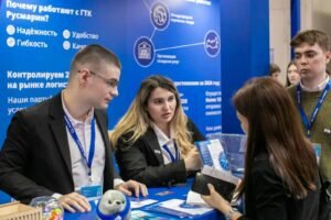 People at a business exhibition visiting a branded trade show booth